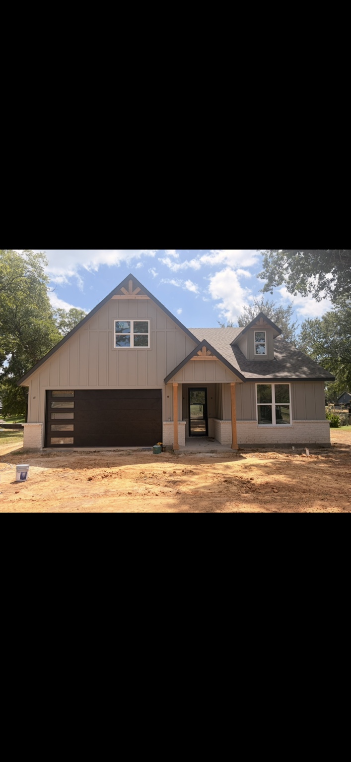 Dark garage door installed on a new construction home